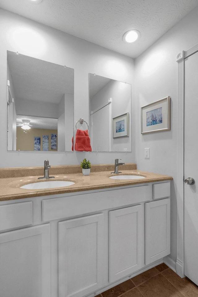 5968 Lisa St, Columbus, OH 43231 - full bathroom featuring double vanity, tile patterned flooring, and a textured ceiling