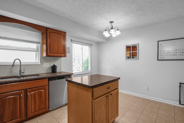 5968 Lisa St, Columbus, OH 43231 - kitchen with stainless steel dishwasher, a sink, backsplash, light tile patterned flooring, and a chandelier