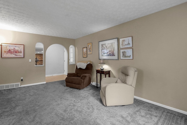 5968 Lisa St, Columbus, OH 43231 - living area with arched walkways, carpet flooring, a textured ceiling, and baseboards