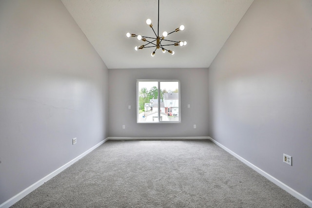 carpeted spare room with baseboards, a notable chandelier, and lofted ceiling