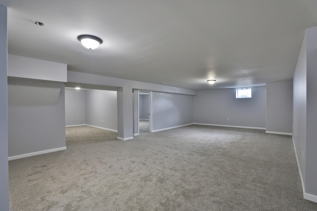 below grade area with baseboards and carpet flooring