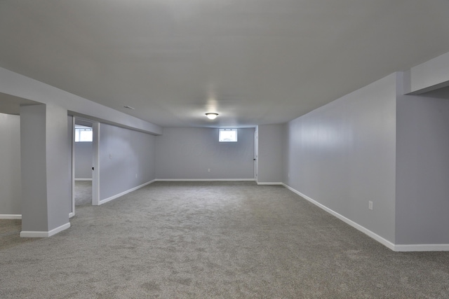 basement with plenty of natural light, carpet floors, and baseboards