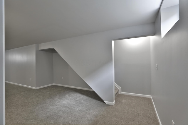 bonus room featuring carpet floors, baseboards, and lofted ceiling