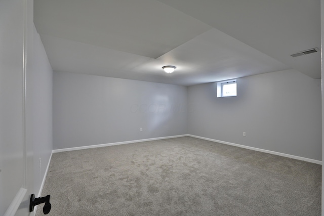 interior space featuring carpet flooring, baseboards, and visible vents