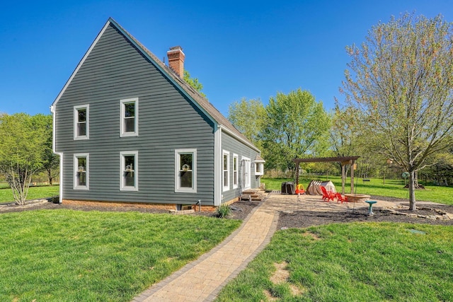 view of property exterior featuring a lawn, a pergola, a chimney, and a patio area