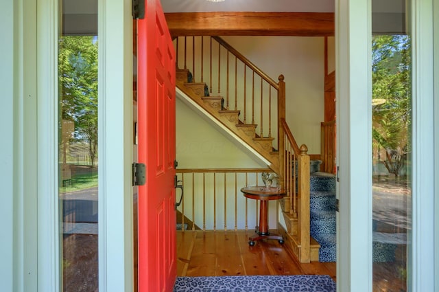 interior space with stairway, wood finished floors, and a healthy amount of sunlight