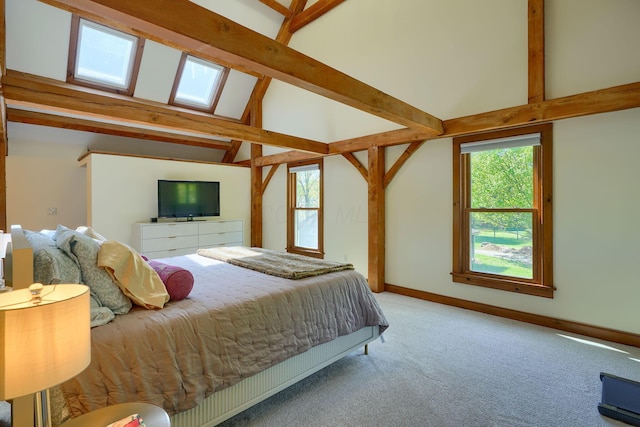 carpeted bedroom featuring baseboards and lofted ceiling with beams
