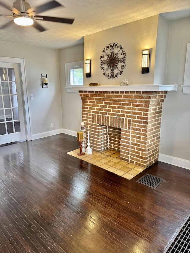 1464 E 26th Ave, Columbus, OH 43211 - unfurnished living room with a fireplace, hardwood / wood-style flooring, ceiling fan, baseboards, and a textured ceiling