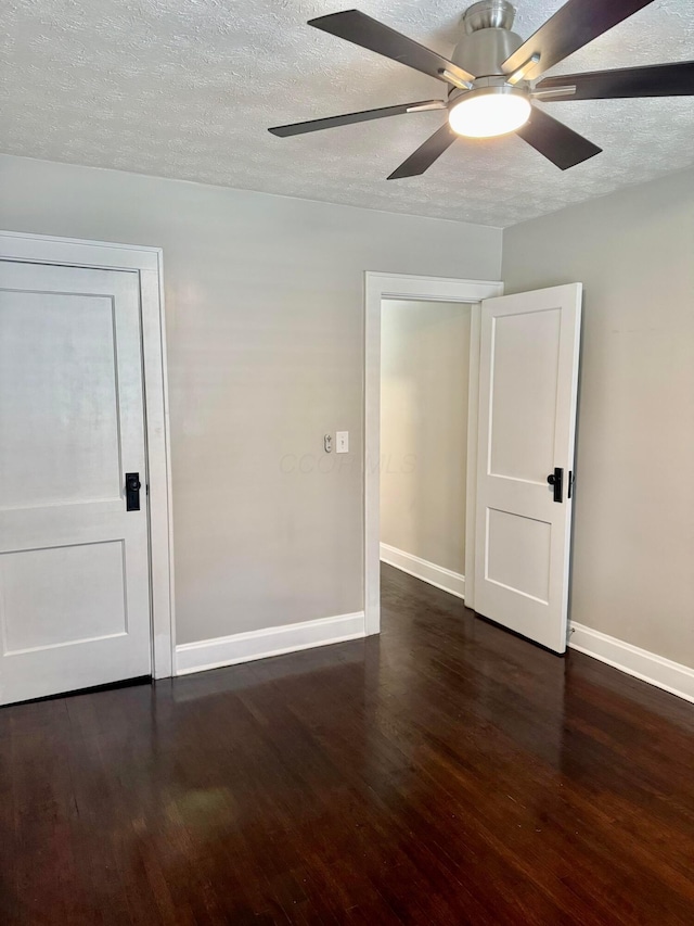 1464 E 26th Ave, Columbus, OH 43211 - empty room with dark wood-type flooring, baseboards, a textured ceiling, and ceiling fan