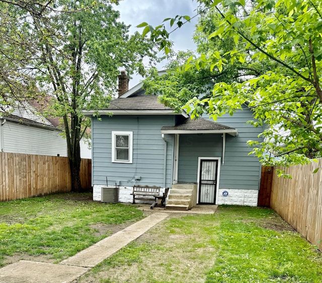 1464 E 26th Ave, Columbus, OH 43211 - rear view of house featuring a chimney, a shingled roof, and cooling unit