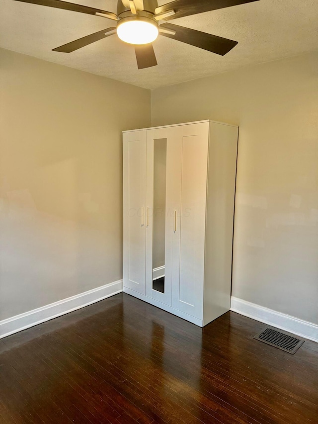 1464 E 26th Ave, Columbus, OH 43211 - unfurnished bedroom with wood-type flooring, baseboards, and a ceiling fan