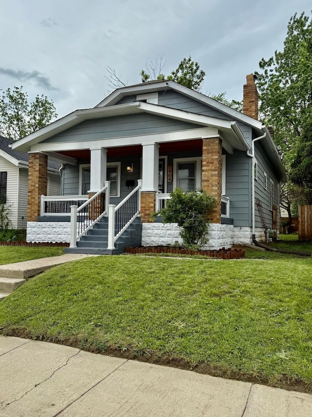 1464 E 26th Ave, Columbus, OH 43211 - bungalow-style home with a chimney, a front yard, and a porch