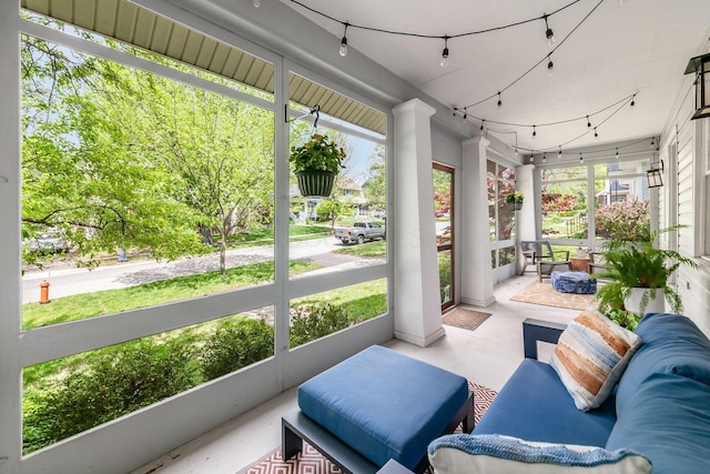 sunroom featuring concrete flooring and a wealth of natural light