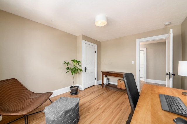 home office featuring light wood-type flooring and baseboards