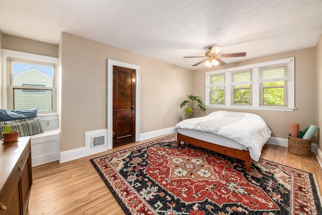 bedroom featuring light wood-style floors, baseboards, and visible vents