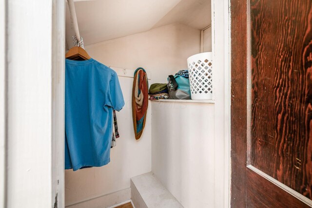 bathroom with baseboards and vaulted ceiling