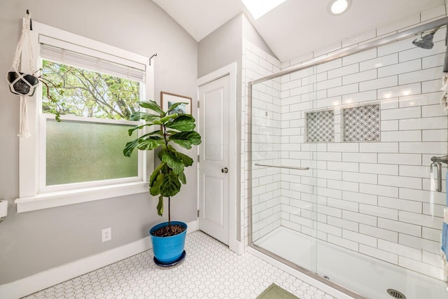 full bathroom with baseboards, lofted ceiling, and a shower stall