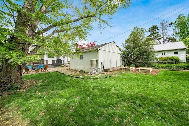 view of yard featuring fence and a garden