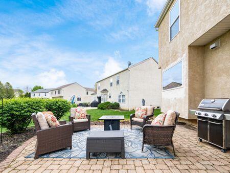 view of patio / terrace featuring an outdoor hangout area, a grill, and a residential view