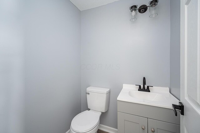 331 E Barthman Ave, Columbus, OH 43207 - bathroom featuring vanity, baseboards, and toilet