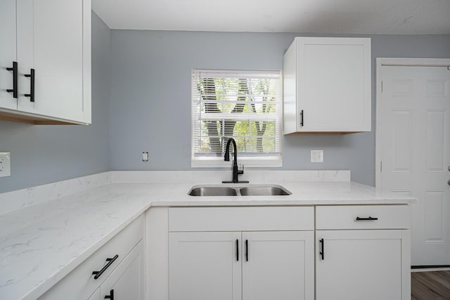 331 E Barthman Ave, Columbus, OH 43207 - kitchen with a sink, white cabinets, and light stone countertops