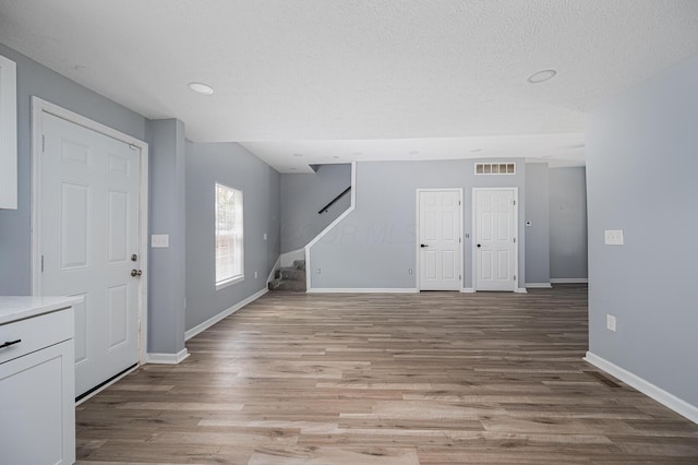 331 E Barthman Ave, Columbus, OH 43207 - entryway featuring baseboards, stairs, light wood-style flooring, and visible vents
