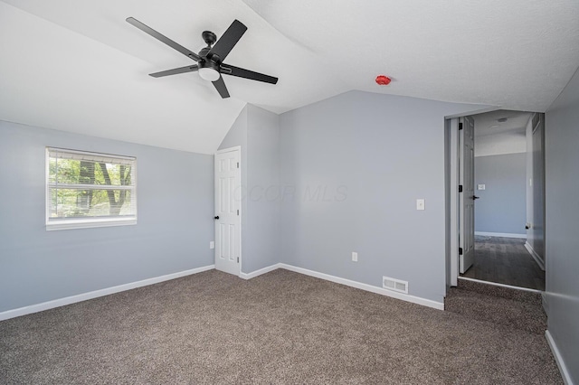 331 E Barthman Ave, Columbus, OH 43207 - unfurnished bedroom with visible vents, dark colored carpet, a ceiling fan, baseboards, and vaulted ceiling