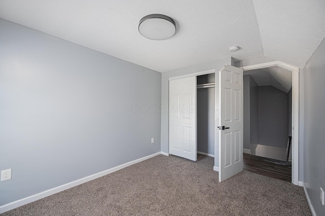 331 E Barthman Ave, Columbus, OH 43207 - unfurnished bedroom featuring dark colored carpet, a textured ceiling, baseboards, and a closet