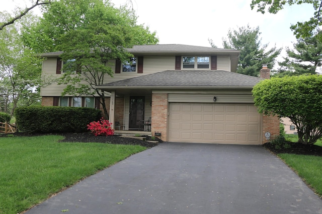 10160 Wellington Dr, Pickerington, OH 43147 - view of front of house featuring brick siding, a garage, and aphalt driveway