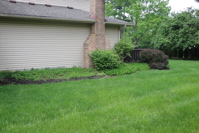 10160 Wellington Dr, Pickerington, OH 43147 - view of side of property with a lawn, a shingled roof, and a chimney