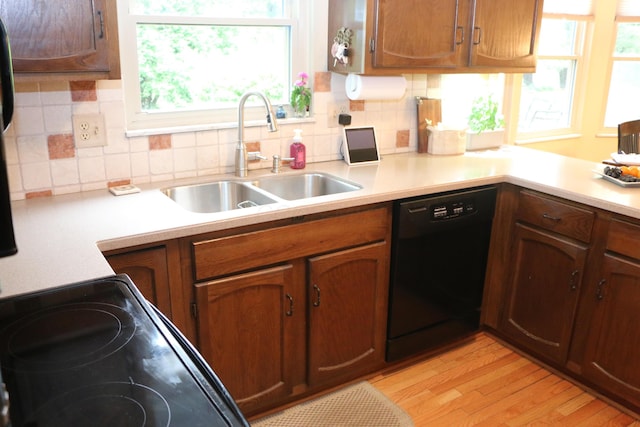 10160 Wellington Dr, Pickerington, OH 43147 - kitchen with a sink, dishwasher, light countertops, light wood-type flooring, and backsplash