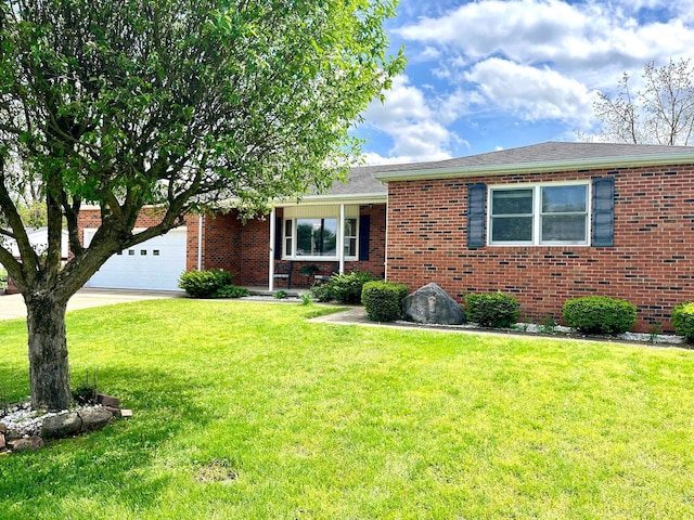 ranch-style home with brick siding, a garage, driveway, and a front yard