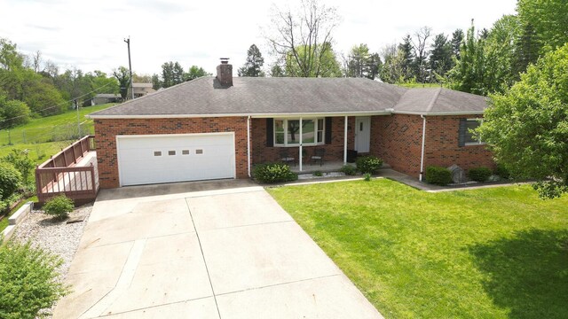 single story home featuring a front lawn, covered porch, a chimney, brick siding, and an attached garage