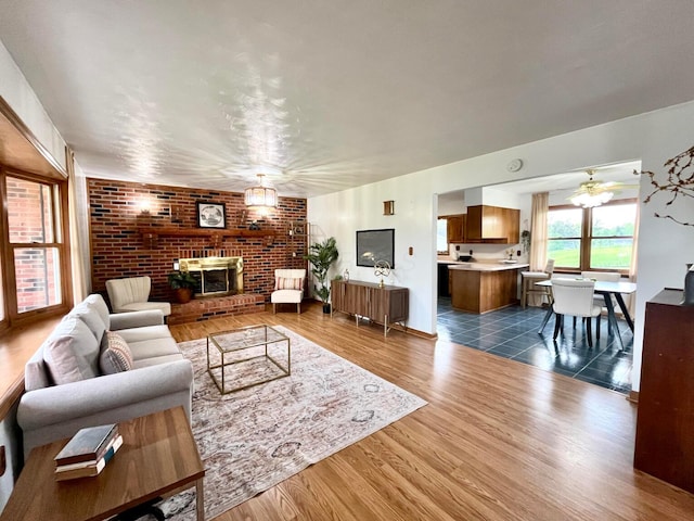 living room featuring ceiling fan and dark wood-type flooring