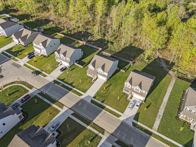 birds eye view of property featuring a residential view and a forest view