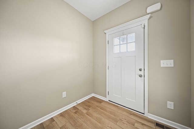 foyer entrance with baseboards, visible vents, and light wood-style floors