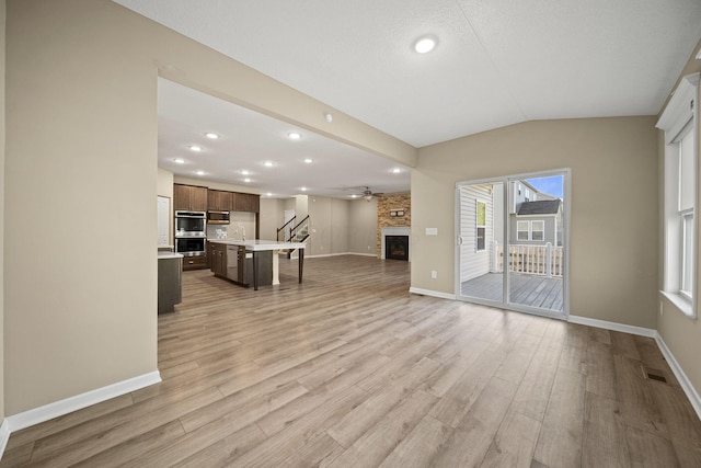 unfurnished living room featuring visible vents, a fireplace, baseboards, recessed lighting, and light wood-style flooring