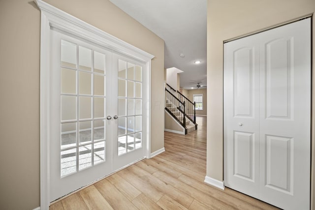 doorway to outside with stairs, baseboards, ceiling fan, light wood-type flooring, and french doors
