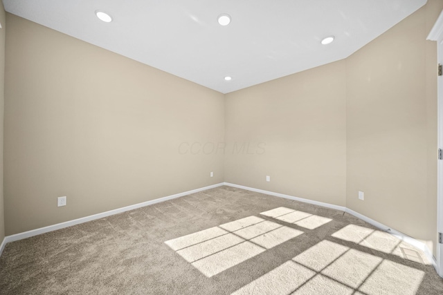 empty room with baseboards, carpet flooring, and recessed lighting