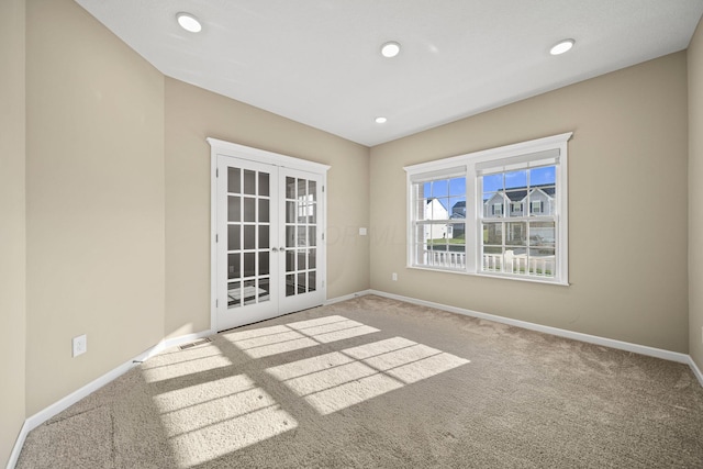 carpeted spare room featuring french doors, recessed lighting, and baseboards