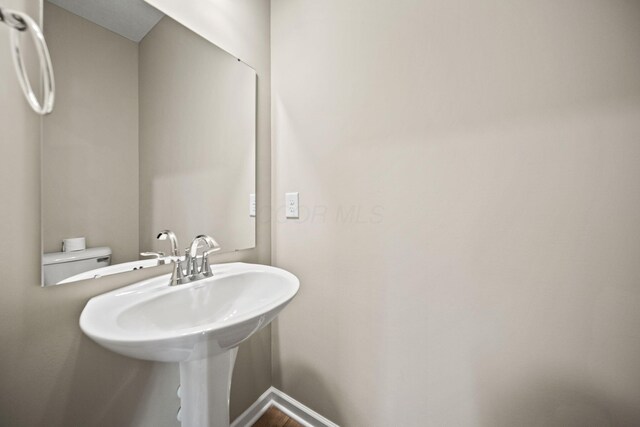 bathroom with baseboards and a sink