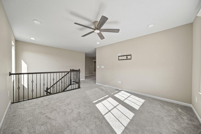 empty room with baseboards, ceiling fan, carpet flooring, and recessed lighting