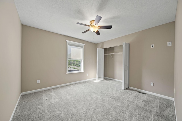 unfurnished bedroom featuring ceiling fan, visible vents, carpet floors, baseboards, and a closet