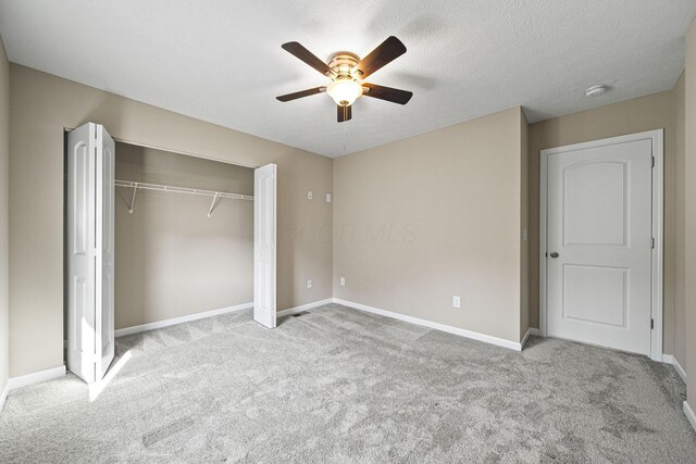 unfurnished bedroom with carpet flooring, baseboards, and a closet