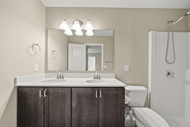 bathroom with a sink, an inviting chandelier, toilet, and a shower