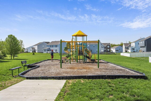 communal playground with a lawn and a residential view