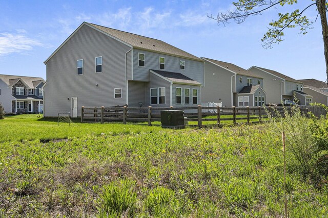 rear view of property with fence