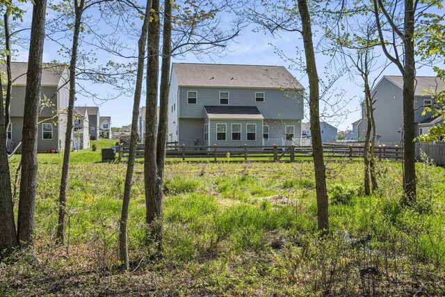 back of house with fence and a residential view