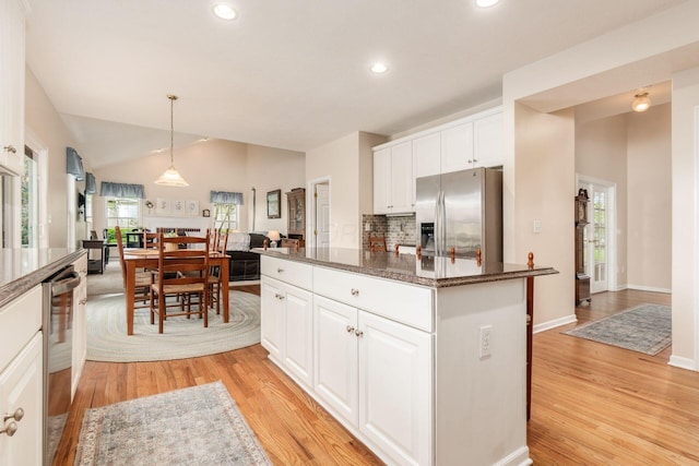 kitchen featuring light wood finished floors, stainless steel appliances, recessed lighting, white cabinetry, and a kitchen island