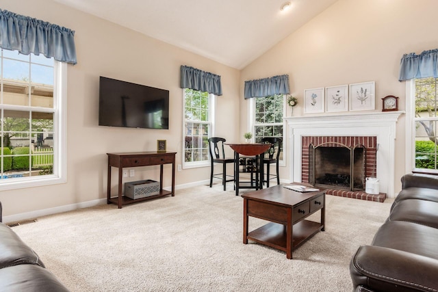 carpeted living room with baseboards, a fireplace, and high vaulted ceiling